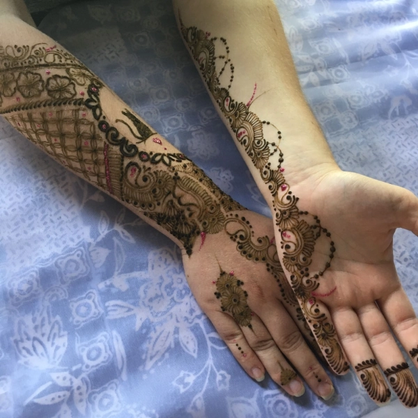Bridal henna on both sides of two arms